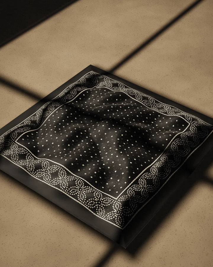 Bindu bandana, crumpled on a concrete floor