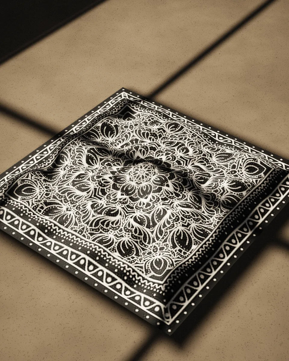 Kolam bandana, crumpled on a concrete floor